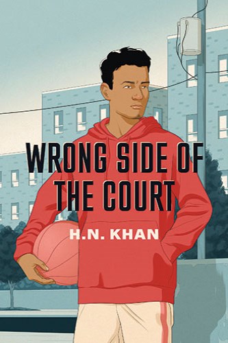 A boy with brown skin standing, holding a basketball in an urban street